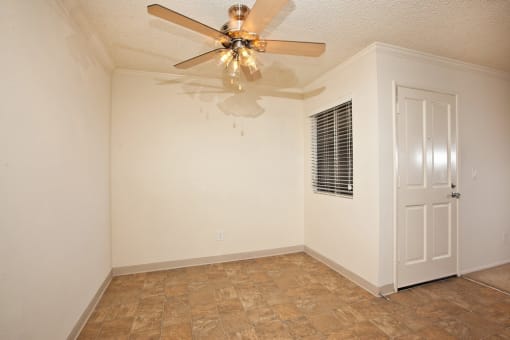a bedroom with a ceiling fan and a door