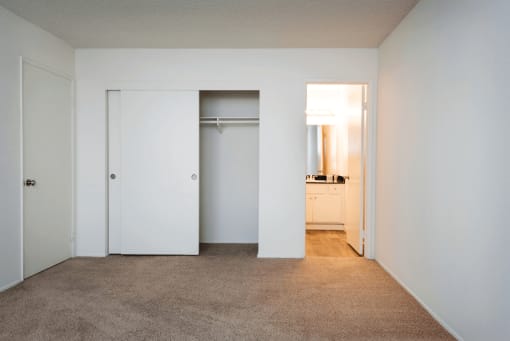 a bedroom with a carpeted floor and white walls