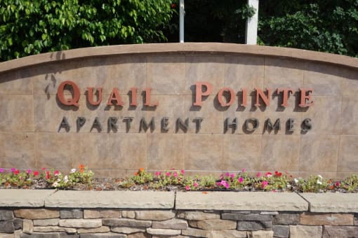 a sign with the words quail pointe apartment homes on it