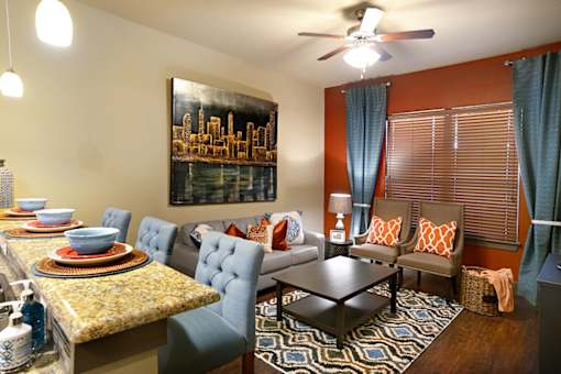 A living room with a dining table and chairs.
