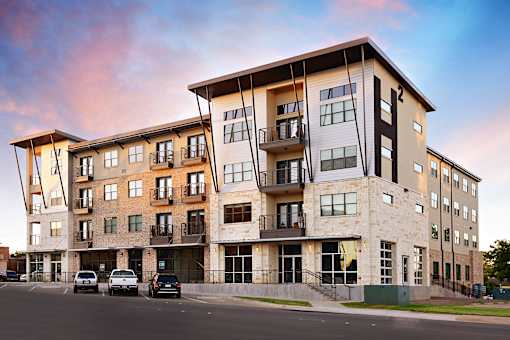 Apartments with a balcony and a covered entrance at H Squared Apartments, Denton, TX, 76201