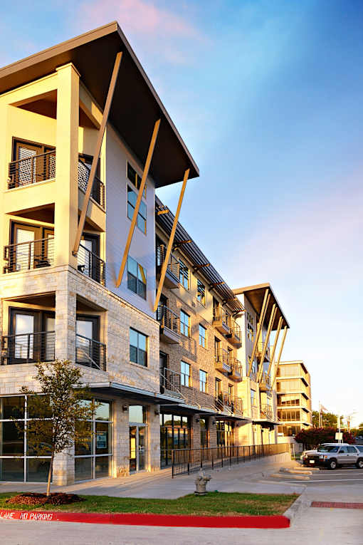 Exterior view of the property with parking at H Squared Apartments, Denton, TX