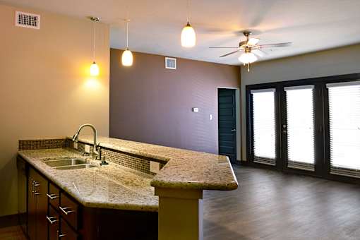 Kitchen with a marble countertop and a sink at H Squared Apartments, Denton