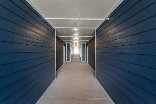 A long, narrow hallway with a light at the end.