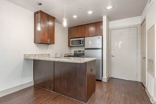 Empty room with cabinet at Hickory Street Lofts Apartments, Denton