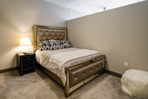 A bedroom with a bed, nightstand, and lamp. at 985 High Apartments, Columbus, OH, 43201