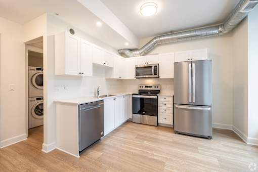 a kitchen with stainless steel appliances and white cabinets