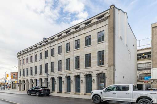 a large white building with many windows on a city street
