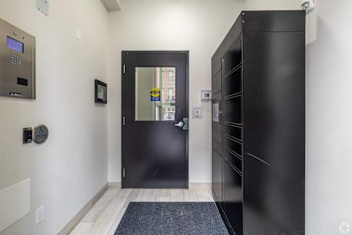 a black door in a white hallway with a black front door