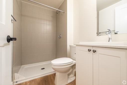 a bathroom with a toilet and a tub and a sink