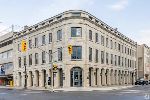a large stone building on the corner of a city street