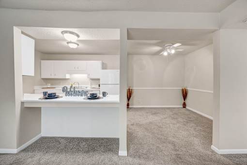 A kitchen with a dining table and chairs.