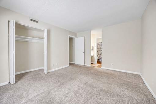 A room with a carpeted floor and white walls.