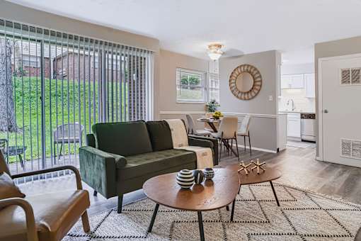 A living room with a green couch and a wooden coffee table.