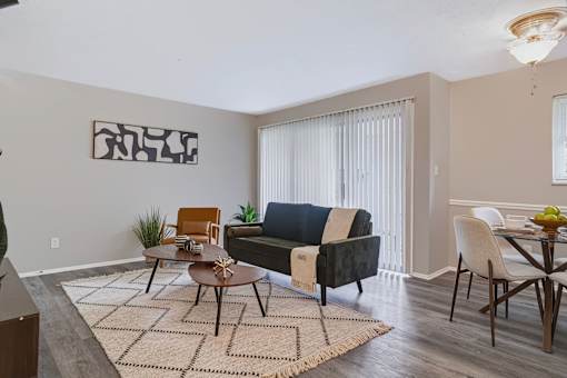 A living room with a couch, chairs, and a coffee table.