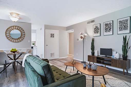 A living room with a green couch and a wooden coffee table.