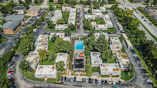 A bird's eye view of a residential area with a swimming pool.