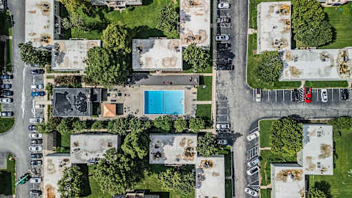 A bird's eye view of a residential area with a swimming pool.