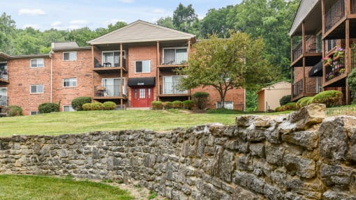 Stone wall outside in the spacious lawn at Heritage Hill Estates Apartments, Cincinnati, Ohio 45227