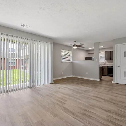 Room with ceiling fan and kitchen view at Lexington Square, Kentucky