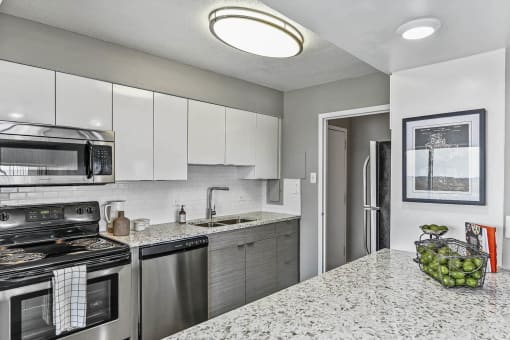 Renovated kitchen with stainless steel appliances and bright lights at CityView on Meridian, Indiana, 46208