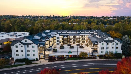 a rendering of an apartment building with a sunset in the background at River Walk Apartments, Idaho, 83702