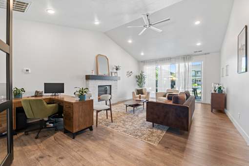 A spacious living room with a home office area.