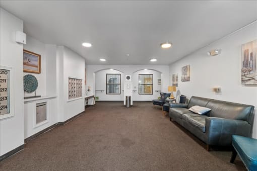 a living room with leather furniture and white walls
