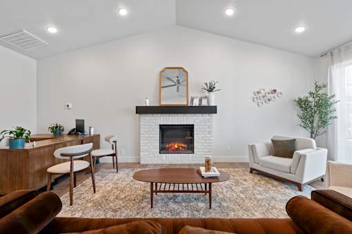 A living room with a fireplace and a mirror on the wall.