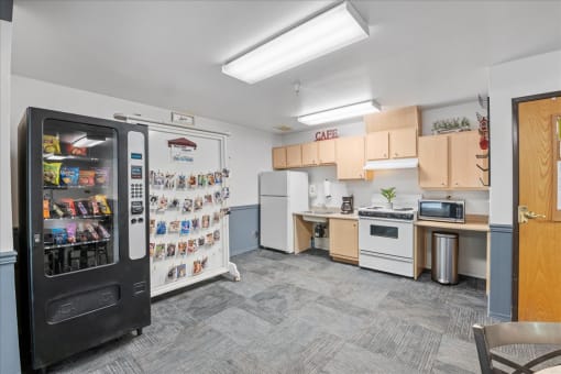 a kitchen with a fridge and a counter with a sink