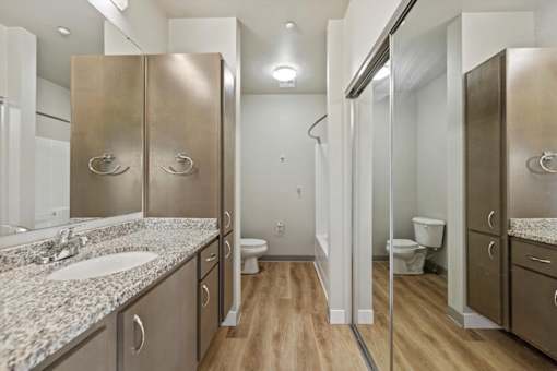 A bathroom with a sink, toilet, and shower.