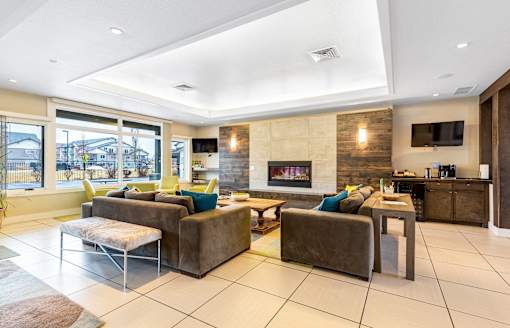 a living room with couches and chairs and a fireplace at Corso Apartments, Missoula, MT