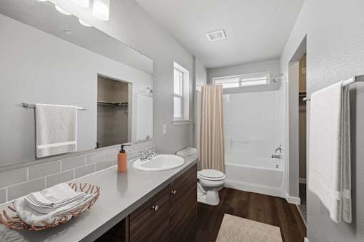the bungalow bathroom has a large mirror and a shower and sink