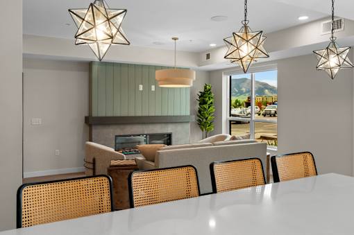 A modern dining room with a large table and chairs at The Beaumont Apartments, Bozeman, MT