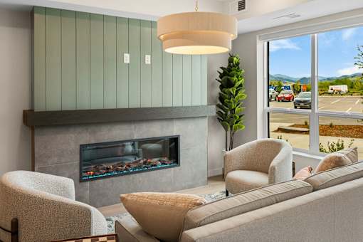 A living room with a fireplace and a couch at The Beaumont Apartments, Bozeman, Montana 59715