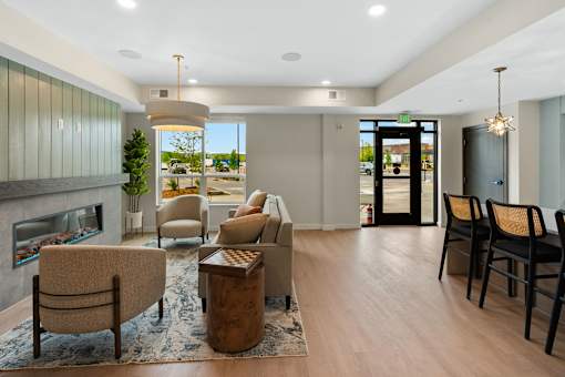 A living room with a fireplace and a view of the outdoors at The Beaumont Apartments, Montana, 59715