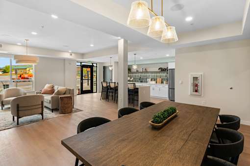 A modern dining room with a wooden table and chairs at The Beaumont Apartments, Bozeman, MT