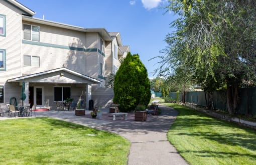 the backyard of a house with a walkway and a patio
