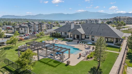 an aerial view of a house with a swimming pool and patio furniture at The Vineyards of Colorado Springs, Colorado Springs, Colorado