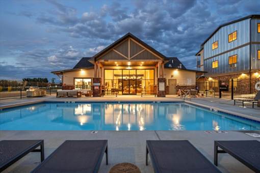 A large house with a pool in front of it.