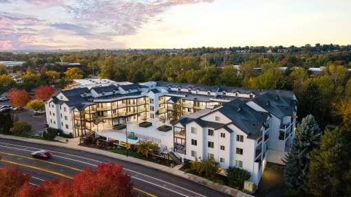 an aerial view of a large white building with a street in front of it at River Walk Apartments, Boise, ID, 83702