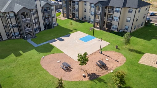an aerial view of an outdoor basketball court in front of an apartment building at The Vineyards of Colorado Springs, Colorado
