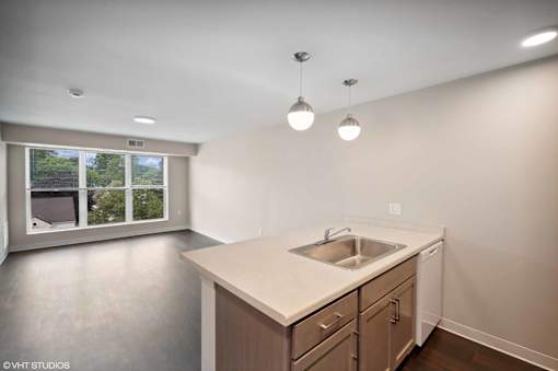 A kitchen with a sink and a window.