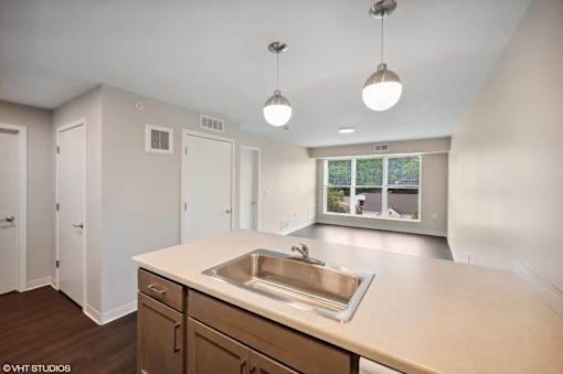 A kitchen with a sink and cabinets.