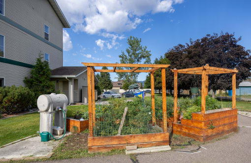 a garden in a yard in front of a house