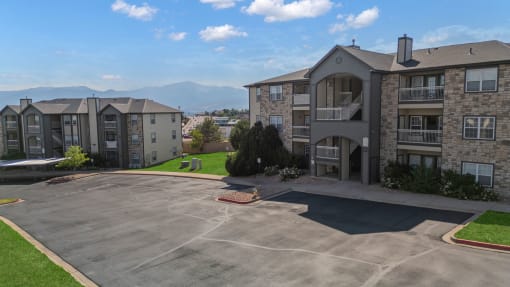 an empty parking lot in front of an apartment building at The Vineyards of Colorado Springs, Colorado Springs