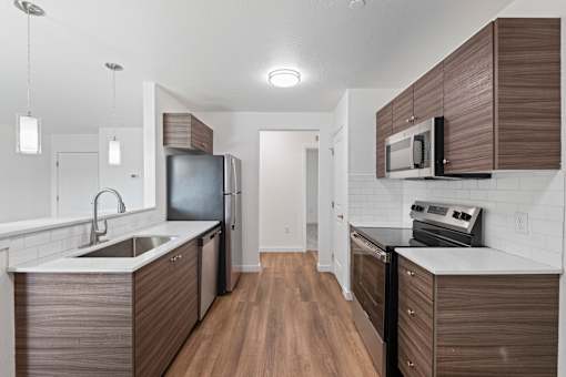 A modern kitchen with dark wood cabinets and white countertops.