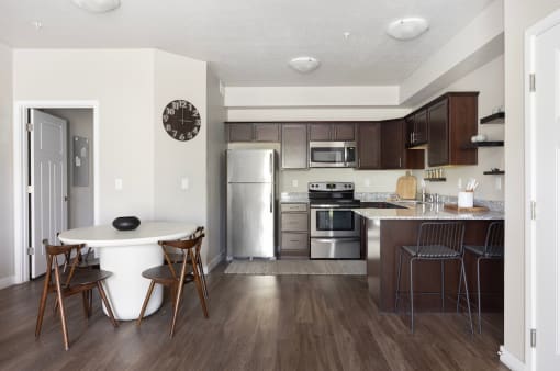 a kitchen and dining area in a 555 waverly unit at The Alloy at Geneva, Utah, 84058