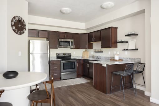 a kitchen with a refrigerator freezer and a stove top oven at The Alloy at Geneva, Vineyard, UT