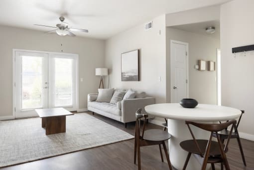 a living room with a couch a table and a ceiling fan at The Alloy at Geneva, Utah